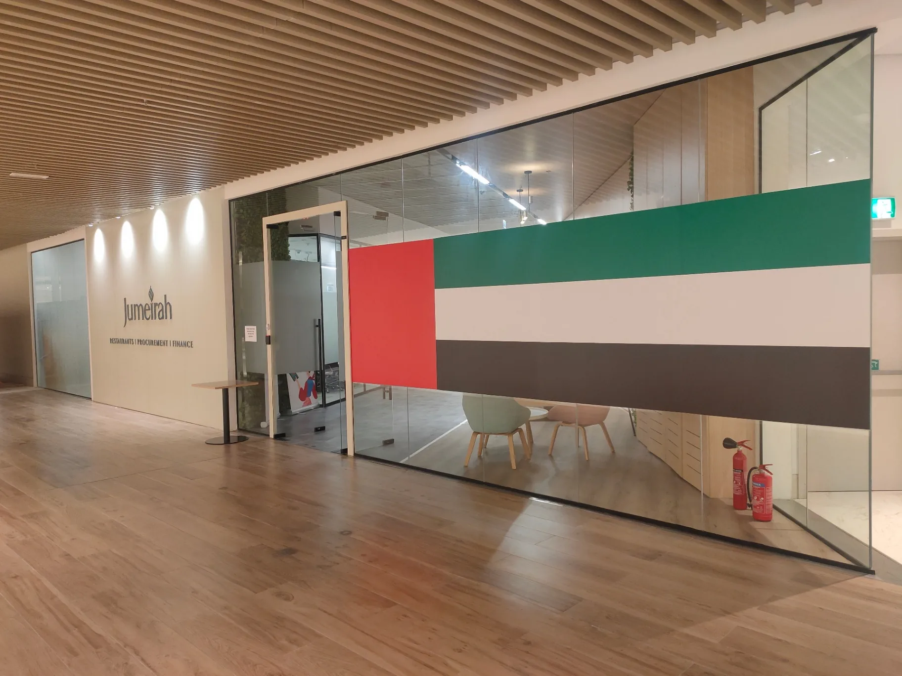 Glass office enclosure with transparent glazing and door framing, used as a door-system design reference