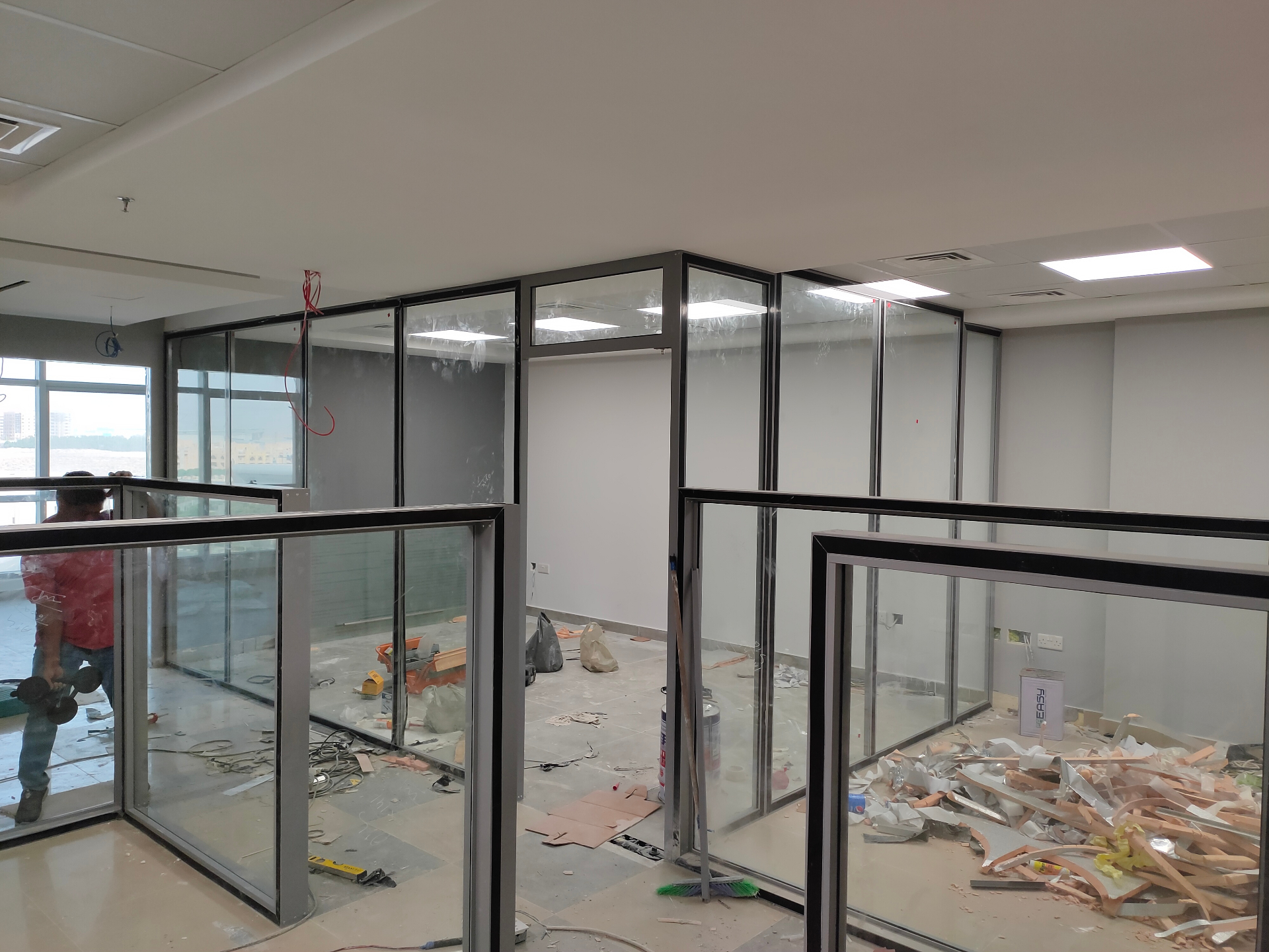 Acoustic glass partitions Dubai — installed office cabins with glazed transoms and integrated doors